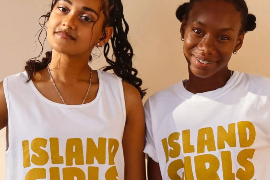 Two girls standing shoulder to shoulder